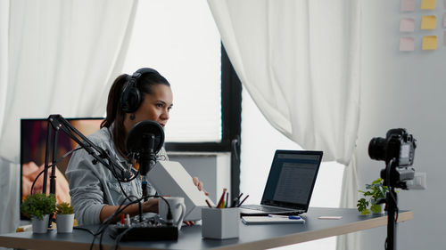 Young woman using laptop at home