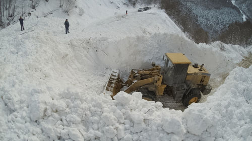 High angle view of people on snow covered land