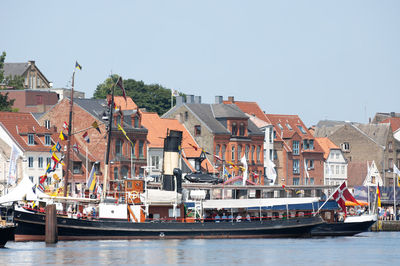 Boats moored at harbor