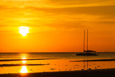 Scenic view of sea against orange sky