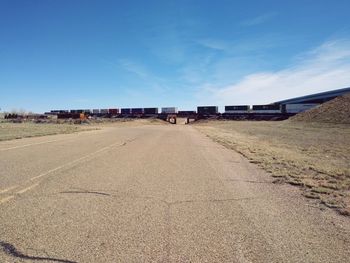 Surface level of road against blue sky