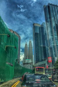 View of skyscrapers against cloudy sky