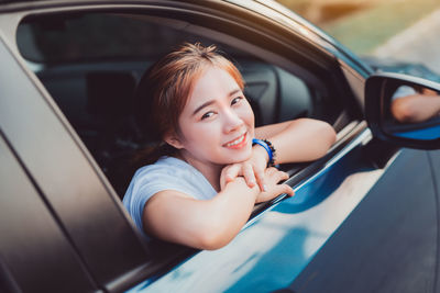 Portrait of happy girl in car