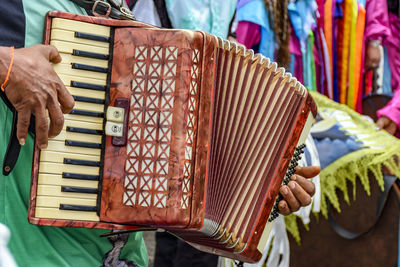 Midsection of man playing drum