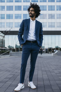 Spain, barcelona, stylish young businessman standing in the city