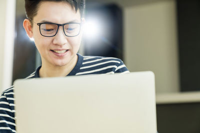 Portrait of smiling man using mobile phone