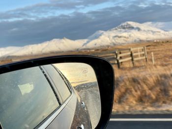 Reflection of sky on side-view mirror