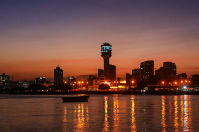 Illuminated city at sunset