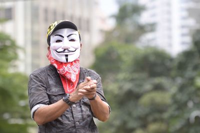 Portrait of man wearing mask while standing outdoors