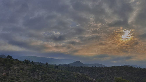 Scenic view of mountains against sky at sunset