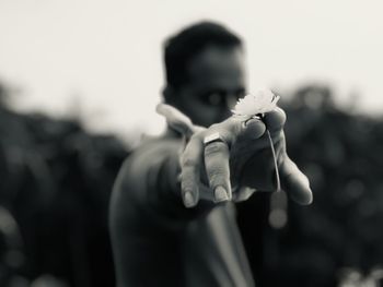 Close-up of man holding flower