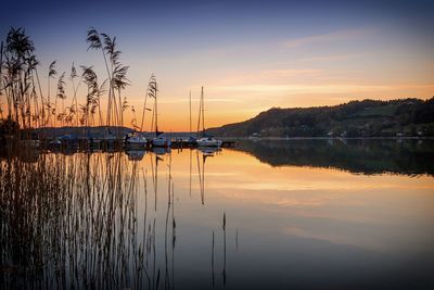 Scenic view of lake against orange sky