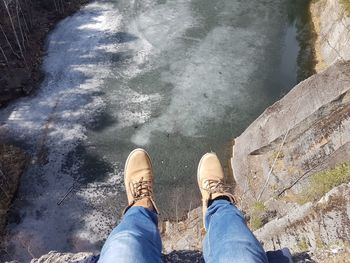 Low section of man standing in water