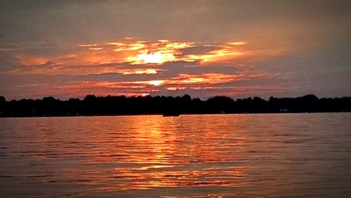 Scenic view of lake at sunset