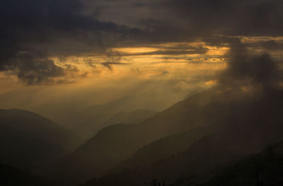 Scenic view of silhouette mountain against sky at sunset