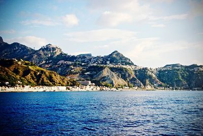 Scenic view of calm lake against mountain range