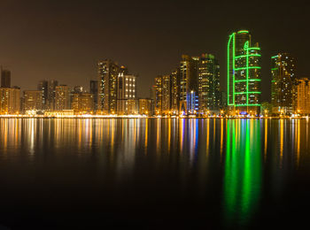 Illuminated city at waterfront