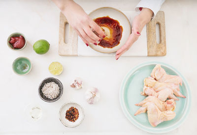 High angle view of hand holding food on table