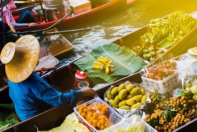 High angle view of man selling fruits in boat on lake