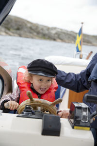 Smiling girl steering boat