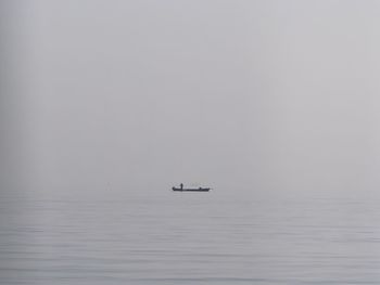 Boat sailing in sea against sky