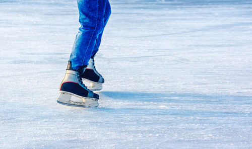 Low section of person skating on ice