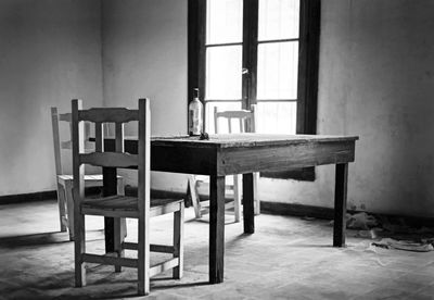 Empty chairs and table in building