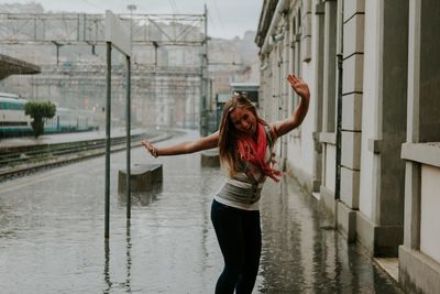 Full length of woman standing on railing