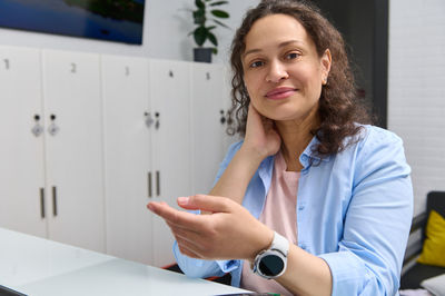 Portrait of young woman using mobile phone