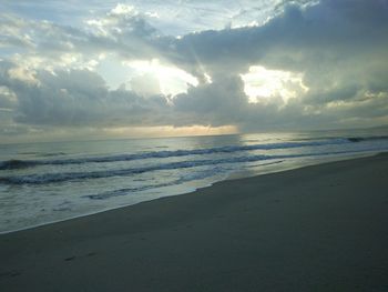 Scenic view of beach against sky during sunset