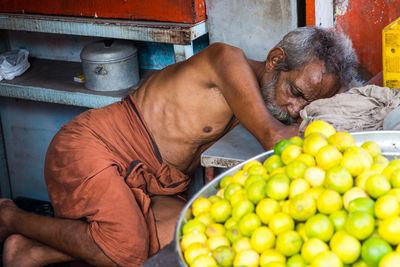 Midsection of man with dog at market