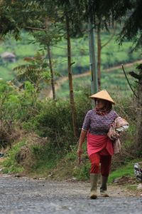 Full length of woman walking in forest