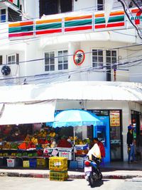 Man and woman at market stall in city