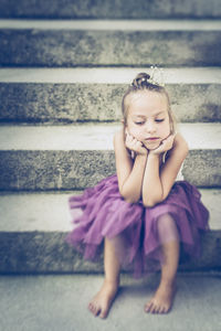 Portrait of girl sitting outdoors