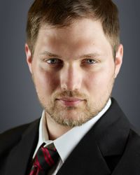 Close-up portrait of man against gray background