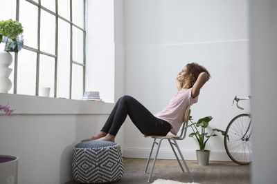 Woman sitting in chair daydreaming