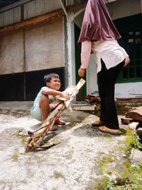 Side view of a man holding woman standing in water