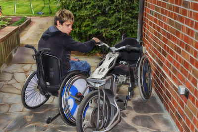 High angle view of boy sitting on motorcycle