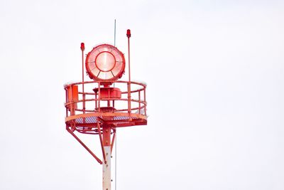 Low angle view of communications tower against sky
