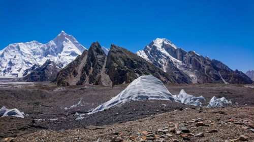 Scenic view of snowcapped mountains against clear blue sky