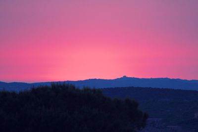Scenic view of mountains against sky at sunset