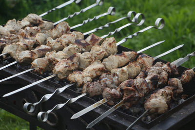 High angle view of meat on barbecue grill