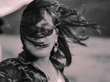 Close-up portrait of woman with tousled hair