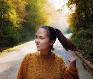 Portrait of a smiling young woman looking away