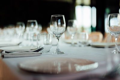 Luxury table settings for fine dining with and glassware, pouring wine to glass. 