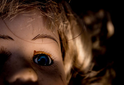 Close-up of doll in darkroom