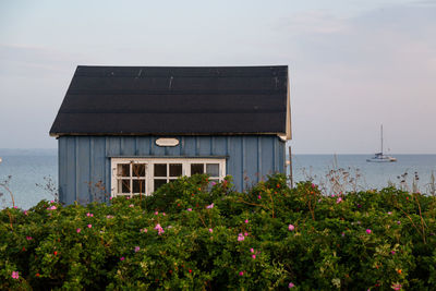 Scenic view of sea by building against sky