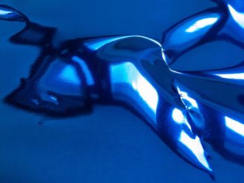 Close-up of sunglasses against blue background