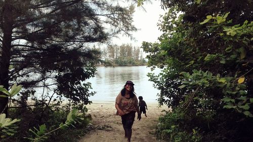 Full length of woman walking in park against sky