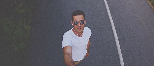 Portrait of young man wearing sunglasses standing outdoors